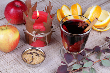 Mulled wine and spices on wooden background