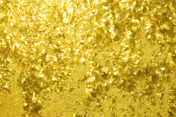 abstract shiny yellow background from a frosty pattern on glass
