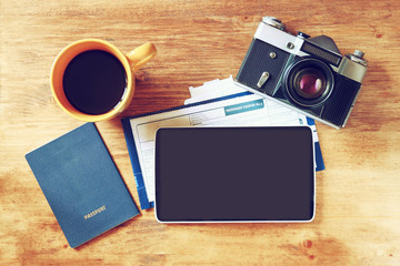 top view image of tablet with empty screen, old camera passport 