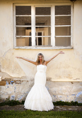 Fototapeta premium Blonde bride by old house