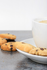 Half cup of coffee with cookies on the table