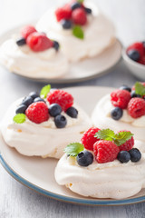 pavlova meringue cake with cream and berry