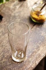close up empty glass on wooden table in restaurant