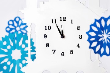 Obraz premium Paper snowflakes and clock. A New Years Eve. 12 o'clock 