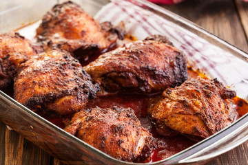 Roasted chicken drumsticks in casserole dish