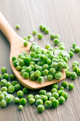  frozen peas on wooden spoon