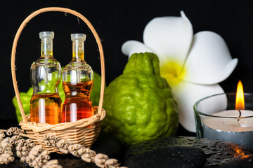 Aromatic spa concept of bottles essential oil in basket, flower,