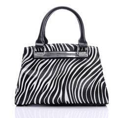 Handbag in zebra pattern on a white background
