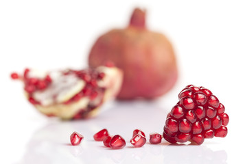 piece and pomegranate seeds on white background