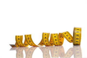 Yellow measuring tape wrapped in a roll