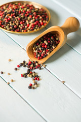 Wooden spoon with colorful chili seeds