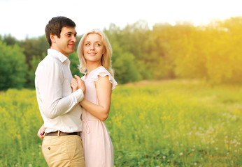 Lovely young couple in love outdoors in summer day