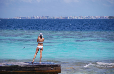 Woman at timber pier making photo