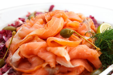 Plate of thinly sliced salmon on plate.