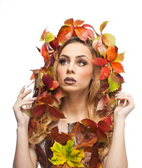 Autumnal woman. Beautiful creative makeup and hair style in fall