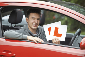 Smiling Teenage Boy In Car Passing Driving Exam