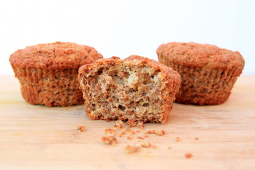Bran muffins on wooden background