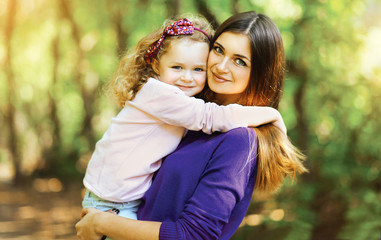 Fototapeta premium Lovely mother and child walking in the park outdoors