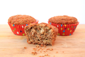 Bran muffins on wooden background