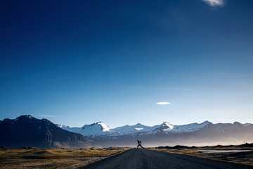 Man jumping on Winding mountain road