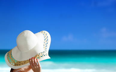woman wearing hat and sunny beach