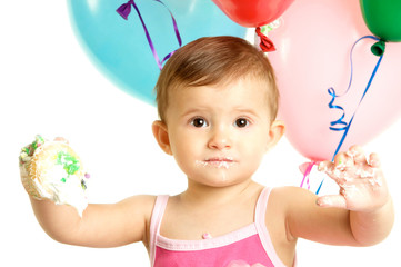 Cute One Year Baby Girl with Birthday Balloons and a Cupcake