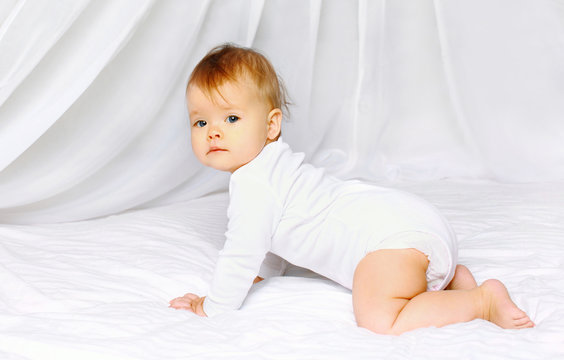 Cute baby crawling on the bed