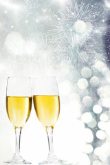Glasses with champagne against fireworks