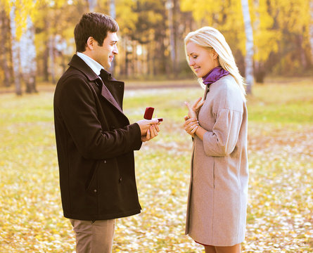 Love, couple, relationship and engagement concept - man proposin
