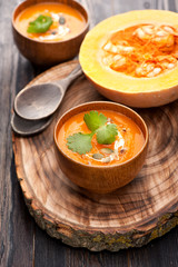 Pumpkin soup on wooden board