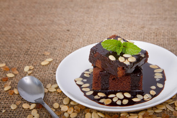 Portion of chocolate cake with mint leaf
