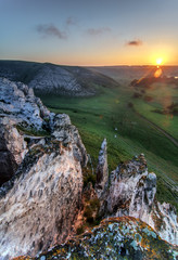 summer landscape on sunrise with chalk mountain, flowers and sun