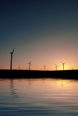 Obraz premium Silhouette of a windmill on sunset, natural background