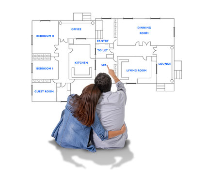 Young couple imaging new house blueprints and planning
