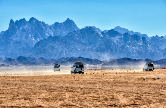 Fototapeta Landscape of Sahara desert with jeeps for safari.