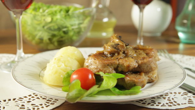 Fried pork chop with mushrooms and potatoes