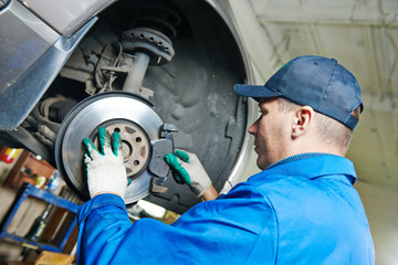 auto mechanic at car suspension repairing