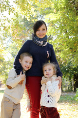 Mother with two kids in autumn park