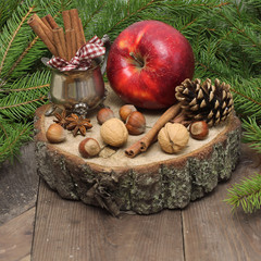 Chistmas composition with cinnamon, nuts and fir branches.