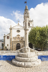 Fototapeta na wymiar Obidos stone pillory in front of Santa Maria church - Portugal