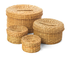 Set of four closed wicker baskets on a white background
