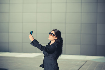 beautiful long black hair elegant business woman with smartphone