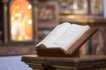 Bible open inside church - obrazy, fototapety, plakaty