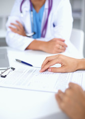 Doctor and patient sitting on the desk  at office