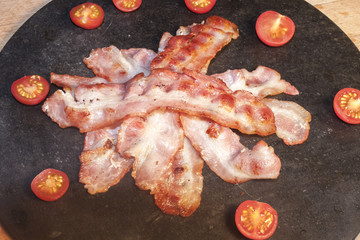 Fried bacon and cherry tomatoes