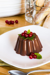 Creamy chocolate pudding with raspberries and mint
