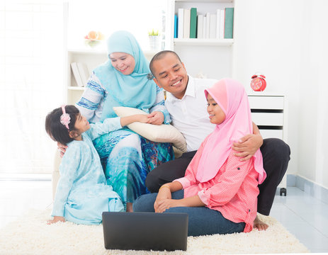 Southeast Asian Family Surfing Internet At Home. Muslim Family L