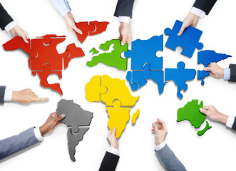 Business People with Jigsaw Forming World Map