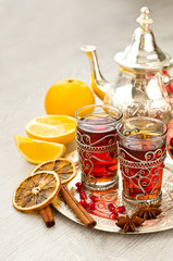Traditional arabic tea with metal teapot and glasses vertical