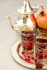 Traditional arabic tea with metal teapot and glasses vertical